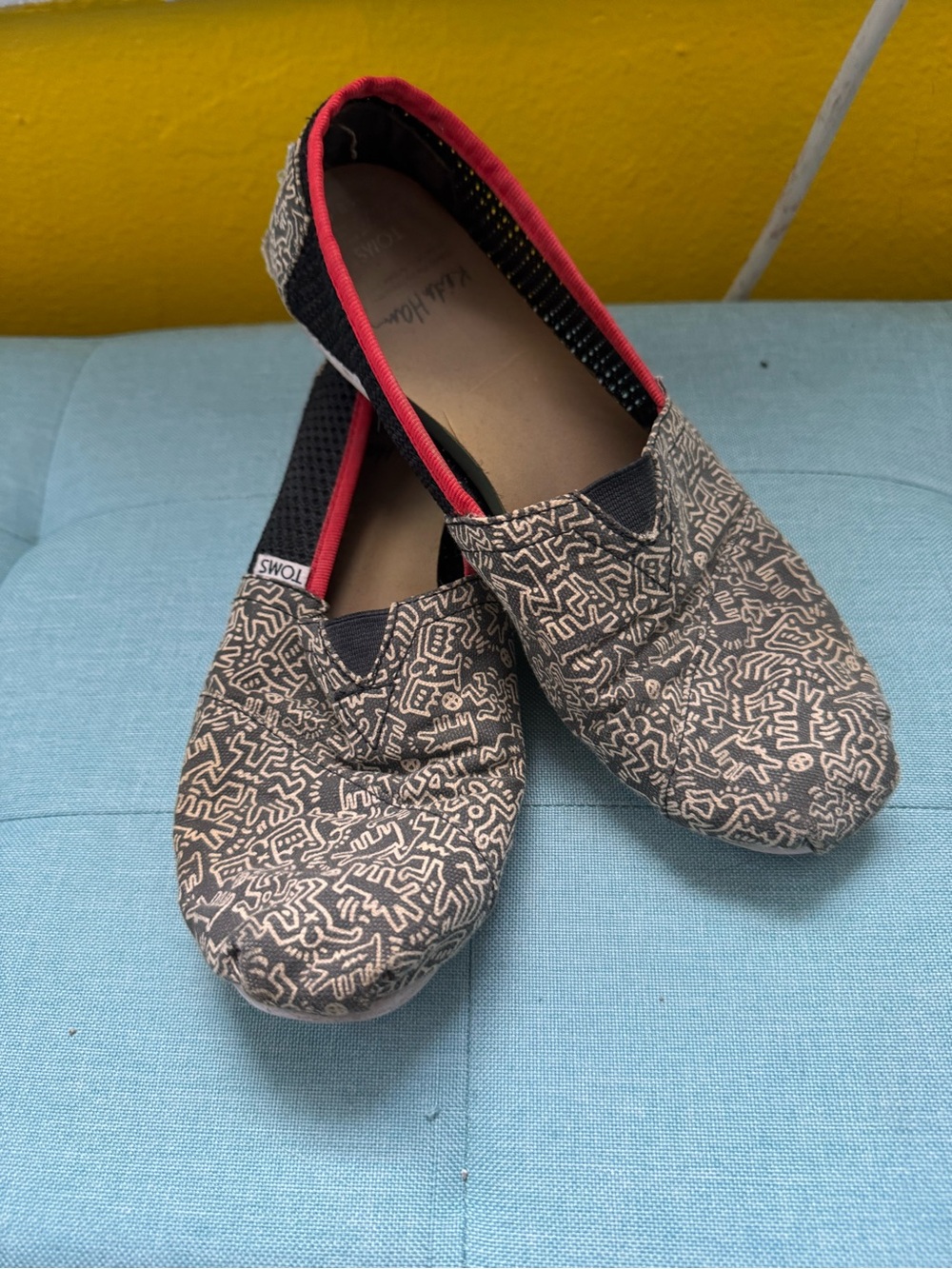 Toms Women's Keith Haring Black Canvas Slip-Ons with Red Trim